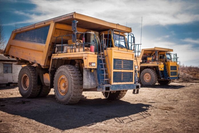 Two yellow dump trucks